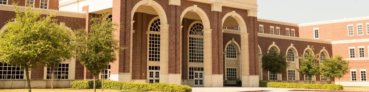 The front of an impressive old college building