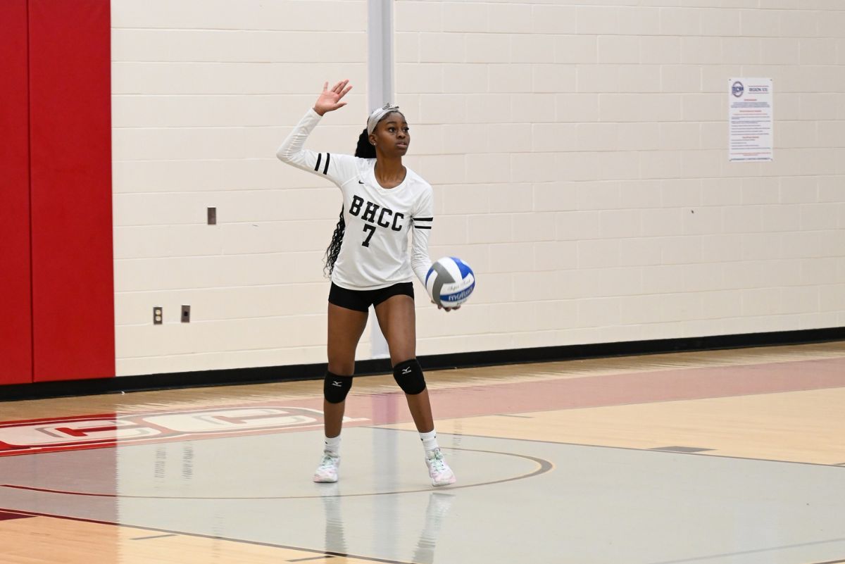 Volleyball player at a bhcc game about to serve