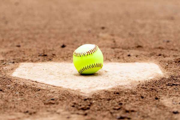 A softball on a baseball field plate