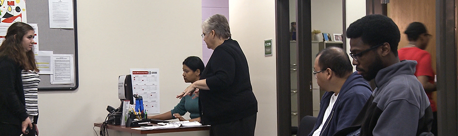 students waiting in an office