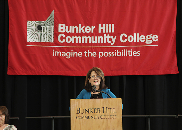 Donna Misrati speaking at the podium