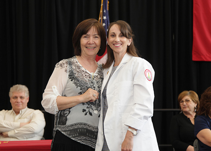 student posing with a faculty member