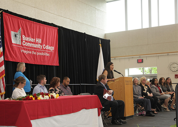 student speaking on stage at the nurse pinning ceremony