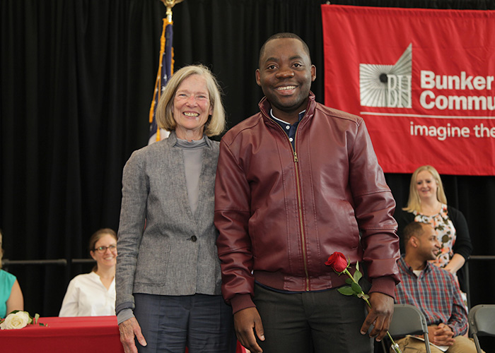 student posing with a faculty member 