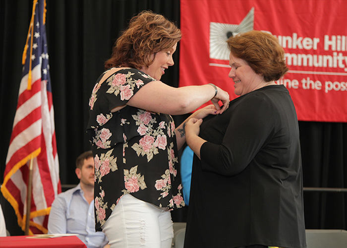 student receiving her nurse pin