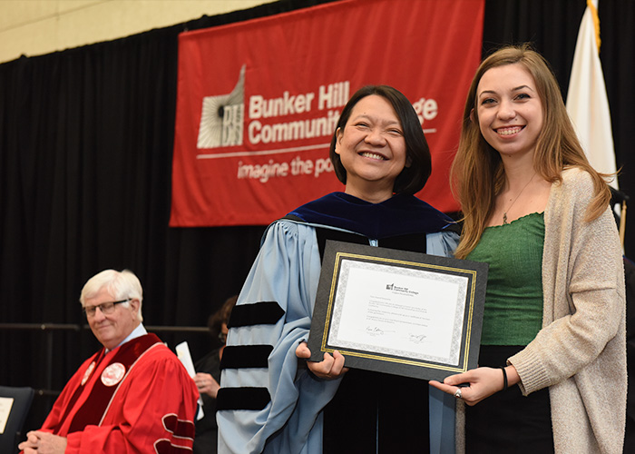 Pam Eddinger presenting a student with an award