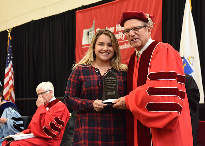 A student receiving her award