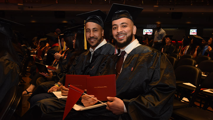 Student graduates posing