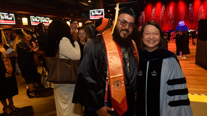 pam and student graduate posing