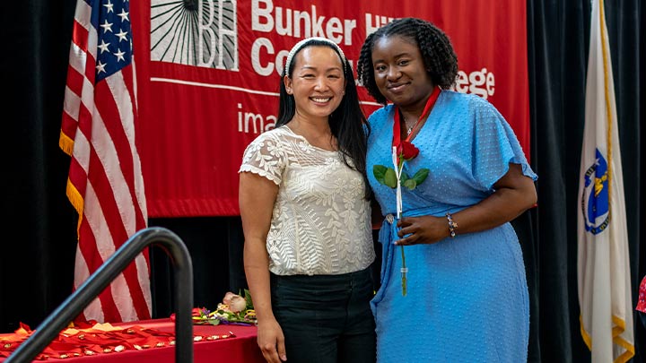 nursing graduate posing with staff