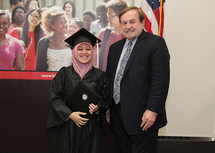 female student posing with dr. canniff and certificate