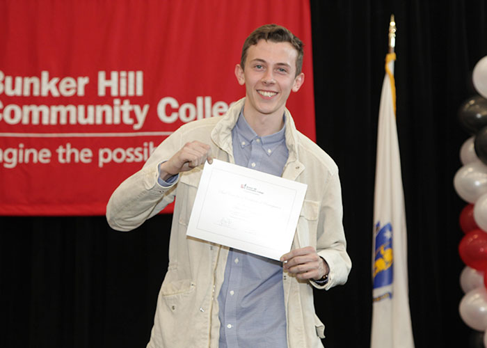 dual enrollment student posing with certifcate