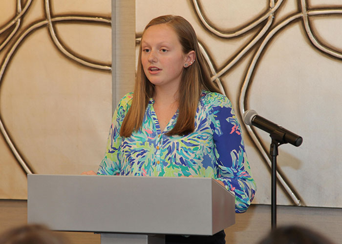 female student speaker at podium