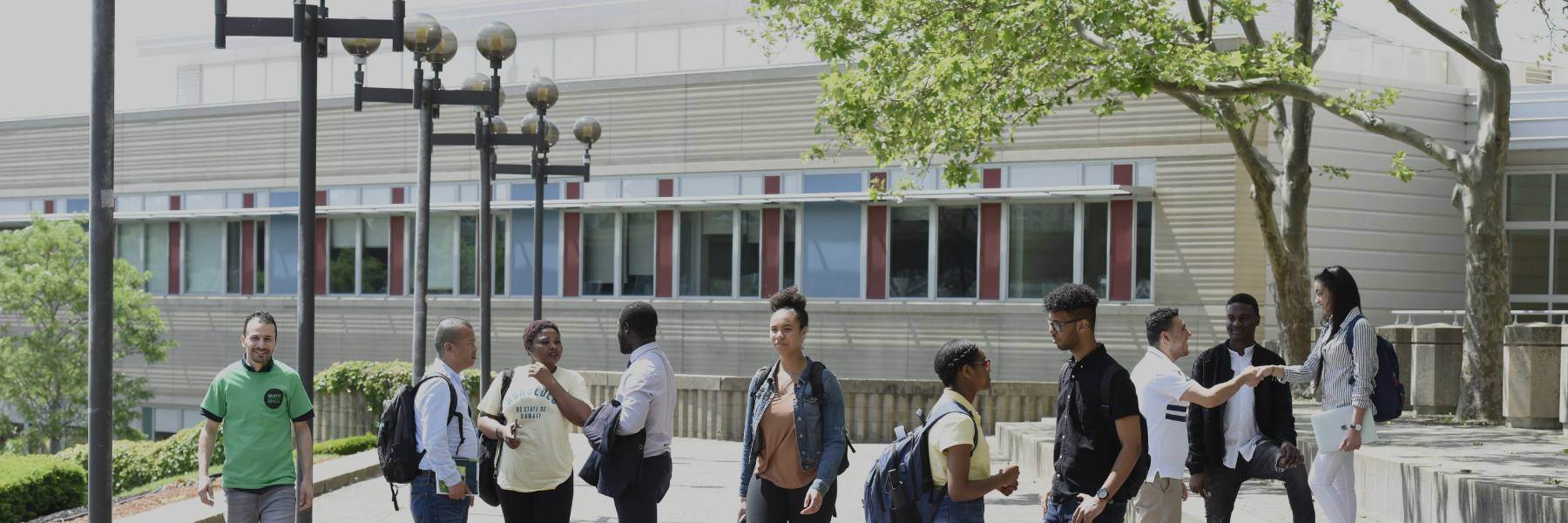 Many students outside on the plaza.