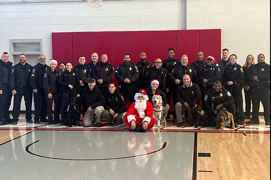 policer officers with santa in the gym