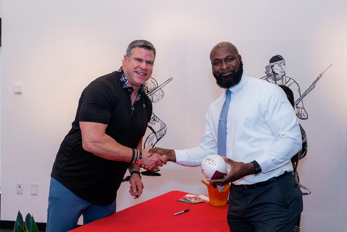 Ted Johnson shaking hands with Justice