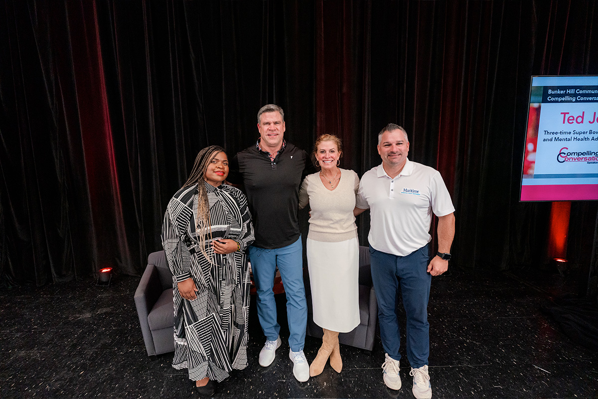 group of people on stage with Ted Johnson