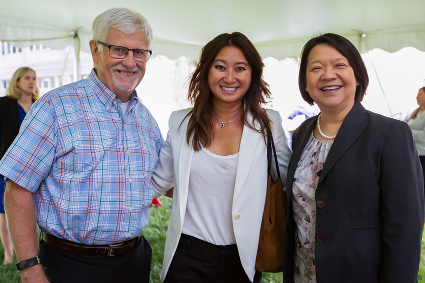 President Pam posing with two event attendees