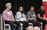 four people talking on stage