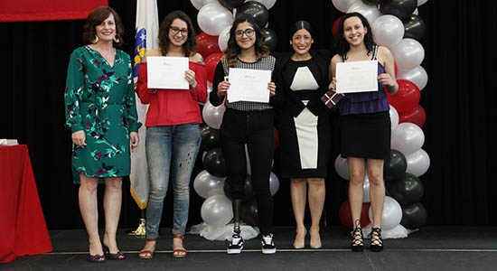 Students with certificates pose with their instructors