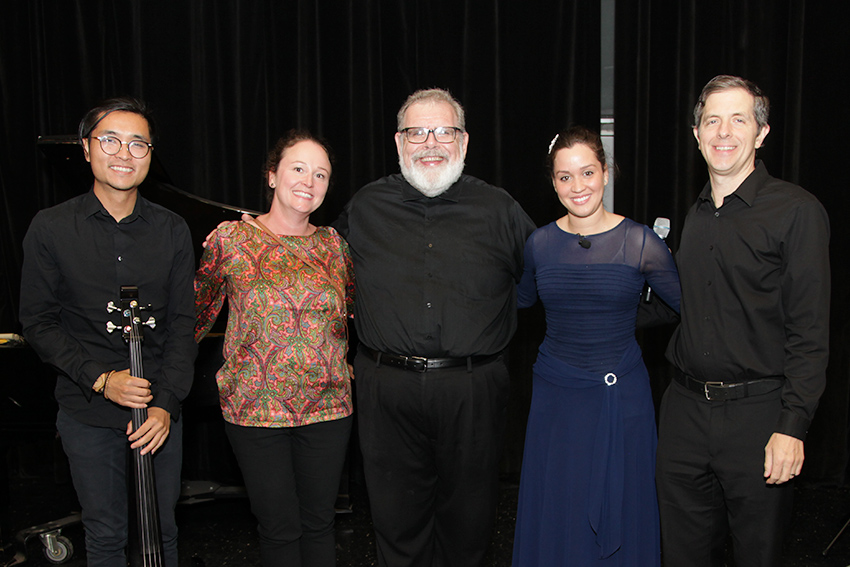 5 people posing on stage