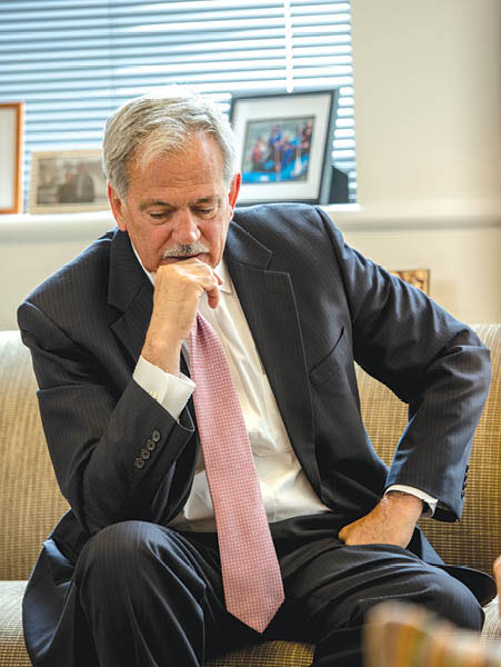 Boston Foundation President and CEO Paul Grogan seated and thinking.