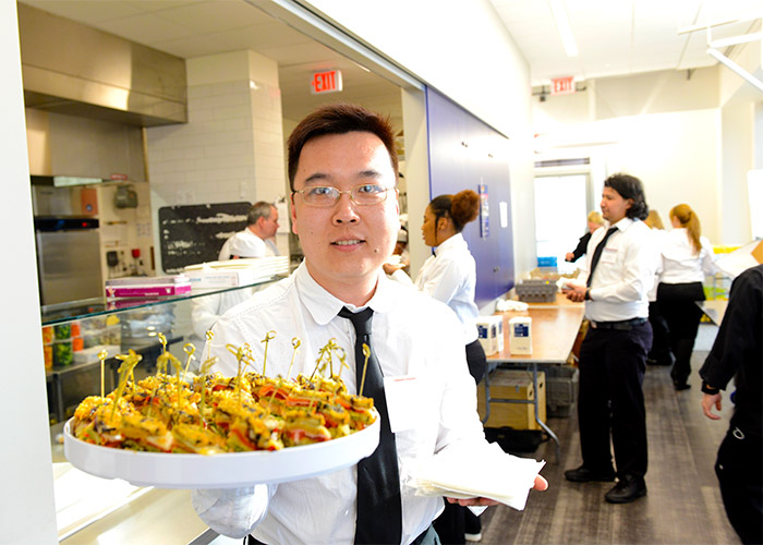 BHCC student serving appetizers 