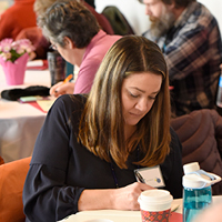 English Professor Laura Carty Barrett participates in writing exercise during Modestin’s Keynote