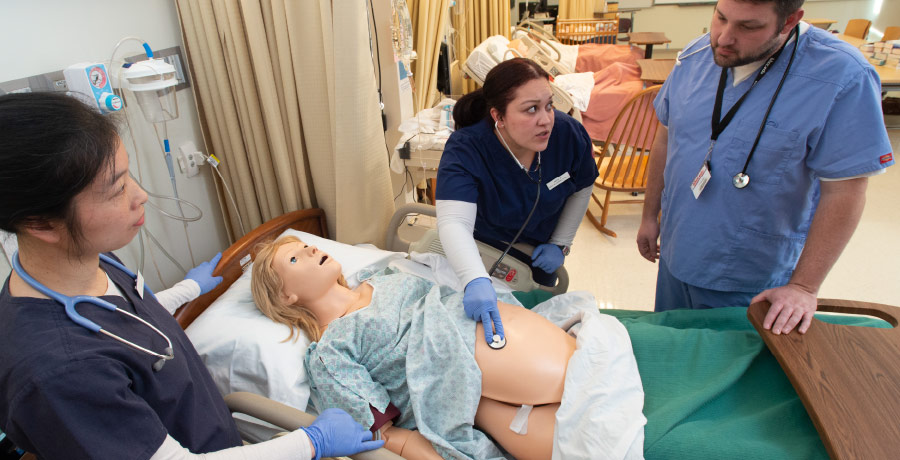 Nursing Article Banner - Students checking for pulse on a patient manikin