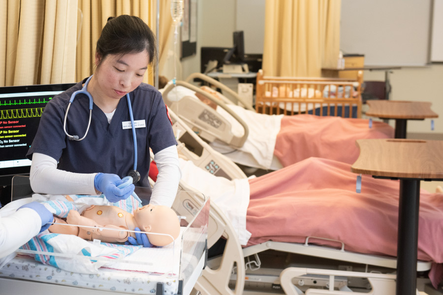2019 Nursing program graduate Tong Mei Lin delivers neonatal care in BHCC’s SIM Skills Lab.