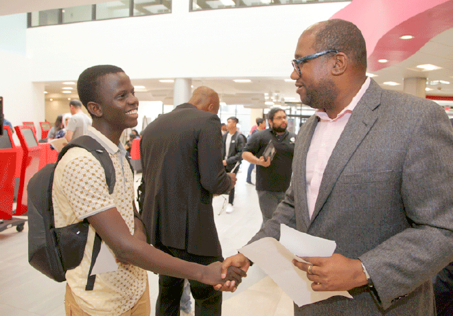 BHCC staff and student shaking hands