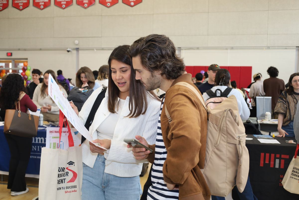 two students looking at brochure