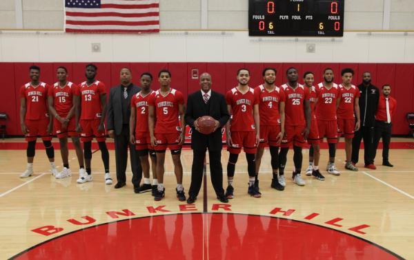 the 2019 men's basketball team standing in the gym