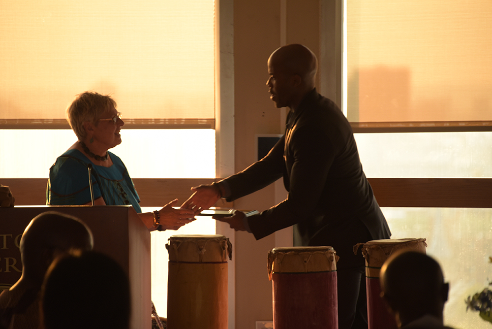 Evans Erilus accepting an award.