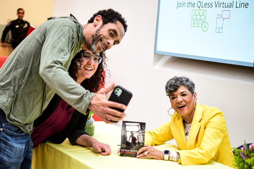 Sonia Manzano posing with 2 people showing her new book