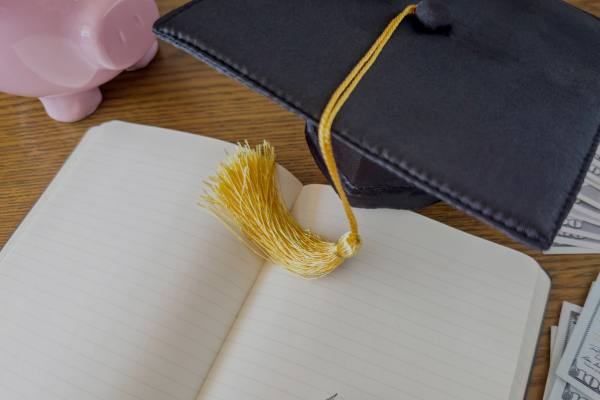 open notebook with graduation cap