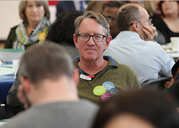 faculty member in audience on professional development day