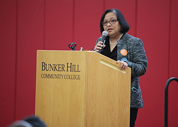 faculty member speaking at podium on stage