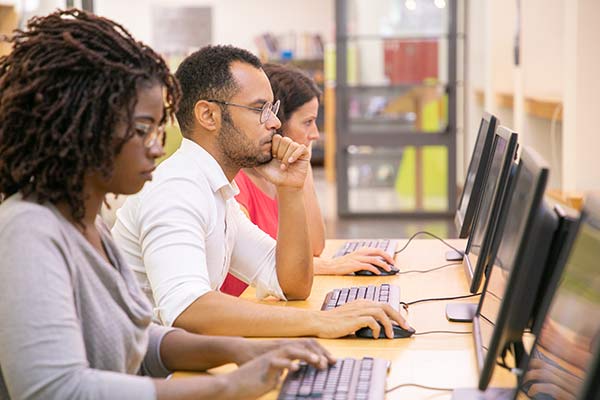 Three students working on computers