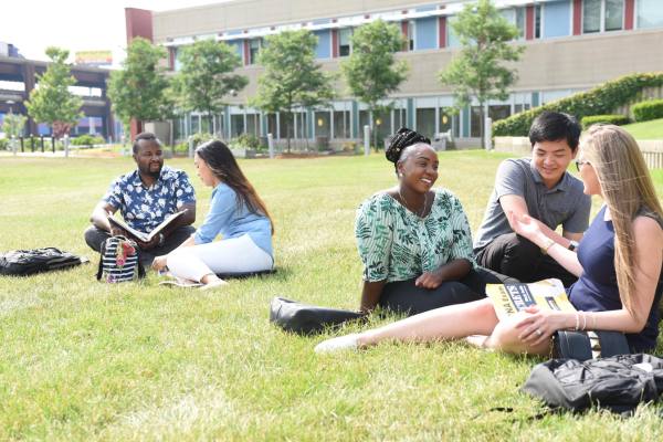 students sitting together on the BHCC lawn